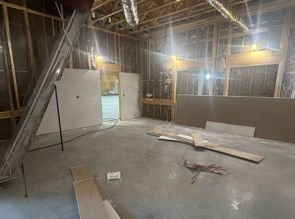In-progress house construction showing drywall texturing and finishing services in Greenville, TX